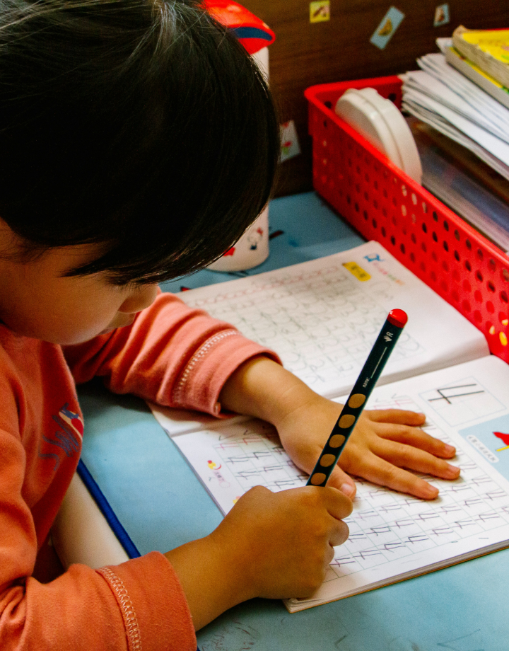 a kid writing notes